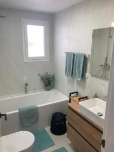 a bathroom with a tub and a toilet and a sink at SUNLIGHT Spain in Manilva +29 photos