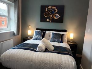 a bedroom with a bed with a white dog laying on it at 2 Bed House - Sleeps 6 - Parking - Wifi in Oldbury