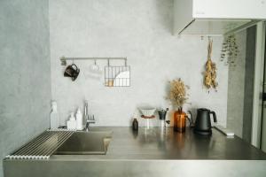 a kitchen with a sink and a counter top at 大洗の眺望抜群なコンテナハウス #一棟貸切 #本格BBQ #大型ガスグリル完備 #大洗 #OURoom1st in Oarai