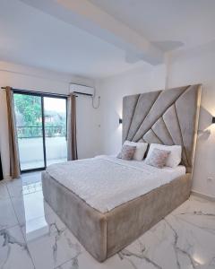 Giường trong phòng chung tại Comfy Home Apart - Appartement T2 meublé Haut Standing Bonapriso, Douala