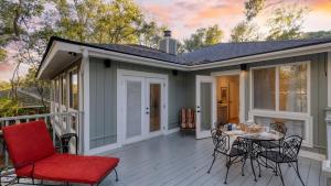 a patio with a table and chairs on a deck at Conch Cottage by AvantStay Walk to Beach Deck Fireplace Outdoor Dining in Isle of Palms