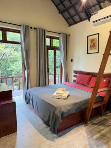 a bedroom with a bed with towels on it at Chez Vous House - Toom Sara in Mang Son