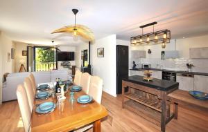 Un comedor y una cocina con mesa y sillas. en Lovely Home In Angoustrine, en Angoustrine