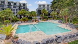 an image of a swimming pool at a resort at 407 A Shipwatch by AvantStay Beach Front Condo w Ocean Views in Isle of Palms
