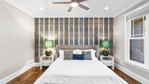 a bedroom with a white bed with two night stands at Luxury Lakefront Stay Private Dock IndoorOutdoor Pool The Retreat in Terrell +54 photos