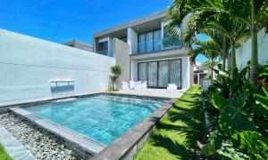 a swimming pool in front of a house at Sanctuary Villa in Ho Tram