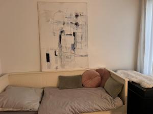 a couch in a living room with a painting on the wall at Residenz am Dreiländereck in Vaals +10 photos