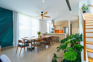 a kitchen and dining room with a table and chairs at Sanctuary Villa in Ho Tram