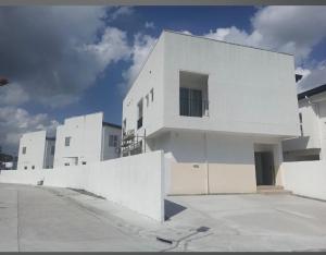 a white building with a fence in front of it at Nemo Villa Clark in Clark