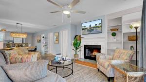 a living room with couches and a fireplace at Ion by AvantStay Walk to Beach Dining Shopping Central Location Deck in Sullivans Island