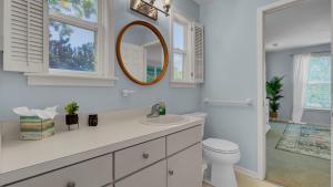 a white bathroom with a sink and a mirror at Ion by AvantStay Walk to Beach Dining Shopping Central Location Deck in Sullivans Island +41 photos