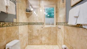 a bathroom with a shower and a toilet at Manitou River House 113 by AvantStay A Location in Telluride +58 photos