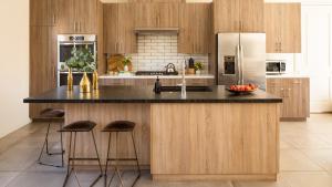 a kitchen with a large island with bar stools at Marilyn by AvantStay Mins to Old Town La Quinta in La Quinta