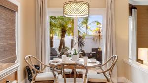 a dining room with a table and chairs and a window at La Paloma by AvantStay Large Private Patio PoolHot TubTennis Court Access in Dana Point