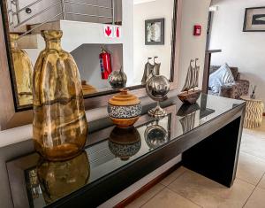 a display case with many vases on a table at Golden Crystal Hotel Gaborone in Gaborone
