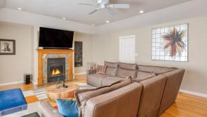 a living room with a couch and a fireplace at Sonoma Hideaway w Private Pool Fire Pit Game Room Guest Studios in Sebastopol