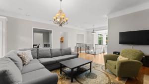 a living room with a couch and two chairs at Whitetail Cove by AvantStay Lakefront w Pool Private Dock Sleeps 20 in Terrell