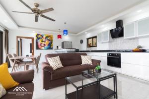 a living room with a couch and a table at Villa Ruby Samantha 2BR with Sea View in Amphoe Koh Samui