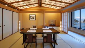 a conference room with a table and chairs and a window at Izu Mitohama Shotokan in Numazu