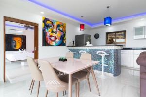 a kitchen and dining room with a table and chairs at Villa Ruby Samantha 2BR with Sea View in Amphoe Koh Samui