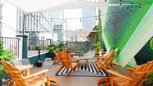 a patio with tables and chairs on a balcony at Sleeps 8 4 SoBro Suites w Kitchens Art Walk to Broadway – by AvantStay in Nashville