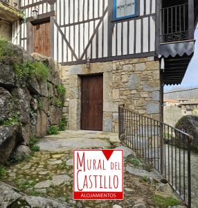 a sign in front of a building with a door at Mural del Castillo II, La Alberca in La Alberca