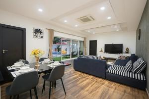 a living room with a couch and a table at Pattaya View Talay Villa-Family Luxury Private Pool Villa,2BR, Walk to Beach in Jomtien Beach