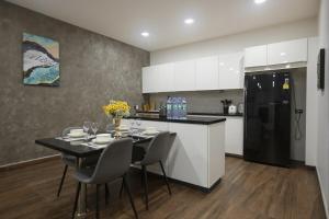 a kitchen with a table with chairs and a refrigerator at Pattaya View Talay Villa-Family Luxury Private Pool Villa,2BR, Walk to Beach in Jomtien Beach
