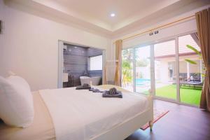 a bedroom with a large bed and a large window at Pattaya View Talay Villa-Family Luxury Private Pool Villa,2BR, Walk to Beach in Jomtien Beach +85 photos