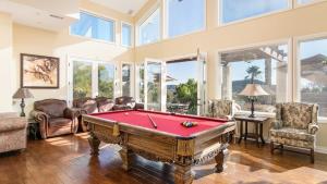 a living room with a pool table and chairs at Private Estate w Pool Hot Tub Tennis Court Near Encinitas The Ranch by AvantStay in Elfin Forest