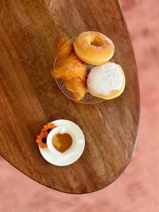 a table with three donuts and a cup of coffee at Isola Di Caprera in Mira