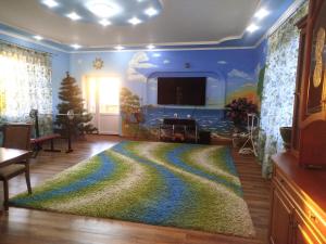 a living room with a large rug on the floor at Sadyba in Khrystynivka