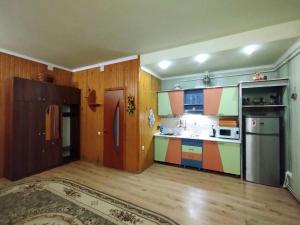 a kitchen with colorful cabinets and a refrigerator at Sadyba in Khrystynivka