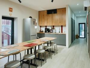 a kitchen with a long wooden table and stools at Skeramos Boutique Art Hotel in Bishkek