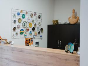 a room with a counter with plates on a wall at Skeramos Boutique Art Hotel in Bishkek +18 photos