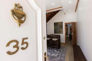 a hallway with a on the wall of a house at De Waterkant Place in Cape Town
