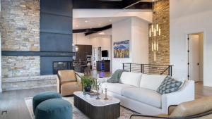 a living room with a couch and chairs and a fireplace at Mins to Deer Valley Lift Firepit Game Room Views 5BDR Orion by AvantStay in Heber City