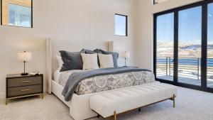 a bedroom with a bed with a view of the ocean at Mins to Deer Valley Lift Firepit Game Room Views 5BDR Orion by AvantStay in Heber City