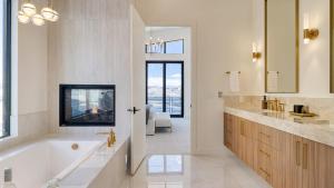 a white bathroom with a tub and a sink at Mins to Deer Valley Lift Firepit Game Room Views 5BDR Orion by AvantStay in Heber City +43 photos