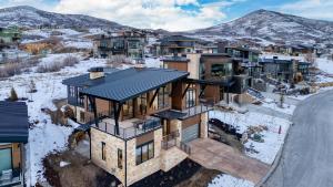 an aerial view of a house in the snow at Mins to Deer Valley Lift Firepit Game Room Views 5BDR Orion by AvantStay in Heber City