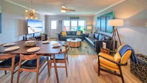 a living room with a table and a couch at Sleeps 16 2 Beachfront Condos PoolPickleballTennis Island Retreat Complex in Port Aransas