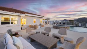 a patio with a table and chairs and a pool at Pool Views Hot Tub Fire Pit Arcade Vista Clara by AvantStay in Temecula