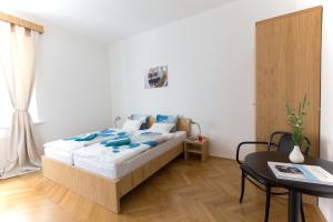 a bedroom with a bed with blue pillows on it at Bed and breakfast Placzek in Brno