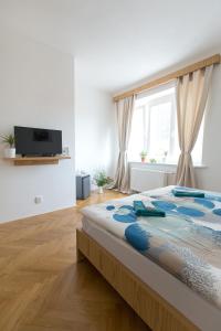 a bedroom with a large bed and a window at Bed and breakfast Placzek in Brno