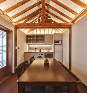 a kitchen with a large wooden table and chairs at Lurury Hanok Stay Reflection in Seoul