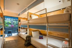 a dorm room with bunk beds and a balcony at Zostel Phuket, Patong Beach Hostel in Patong Beach