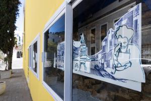a window of a building with stickers on it at De Waterkant Place in Cape Town