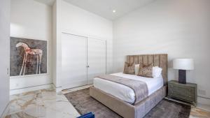 a bedroom with a bed and a painting of a giraffe at Rancho Mirage Oasis w Pool Hot Tub Bocce Putting Green Firepit in Rancho Mirage +38 photos