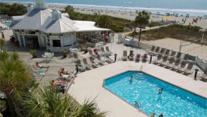 an overhead view of a swimming pool at a beach at 110 Grand Pavilion by AvantStay Direct Access To Grand Pavilion Boardwalk in Isle of Palms