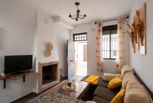 a living room with a couch and a fireplace at Casas Rurales Los Montes in La Corte